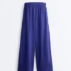 Pantaloni largi din 100% in, cu pli lateral